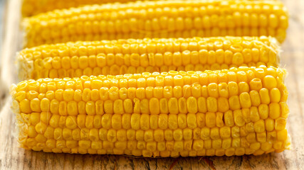 Sweet corn, ready to eat on wooden board