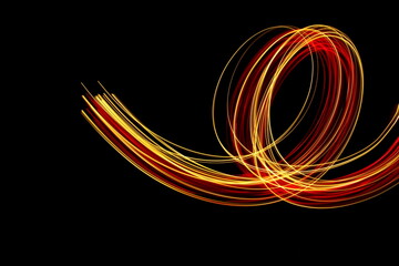 Long exposure photograph of neon red and gold colour in an abstract swirl, parallel lines pattern...