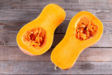 Butternut squash sliced in half. Sliced butternut squash over old wood background.