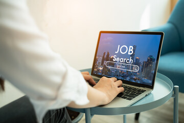 Back view of woman browsing work opportunities online using job search computer laptop app after being laid off during covid-19 or coronavirus outbreak at home.find your career and recruitment concept