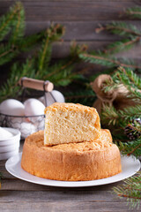 Sponge cake on a Christmas background. Homemade sponge cake on a white plate. Homemade bakery concept