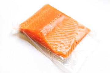 Fresh salmon fillet in vacuum package isolated on white background for delicious salmon steak. 