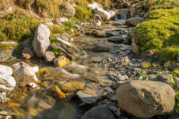 Close-up on the stream flowing along the mountain	