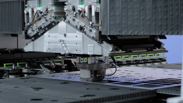 Hydraulic punching and shearing machine working with sheet metal at factory, plant. Metalworking, industrial, equipment, technology, machining, manufacturing concept