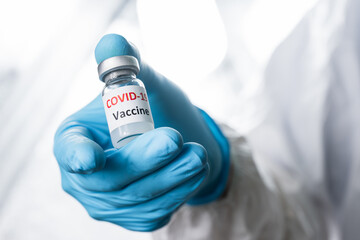 Doctor, nurse, scientist or researcher  holding coronavirus (covid-19) vaccine for clinical trials in human