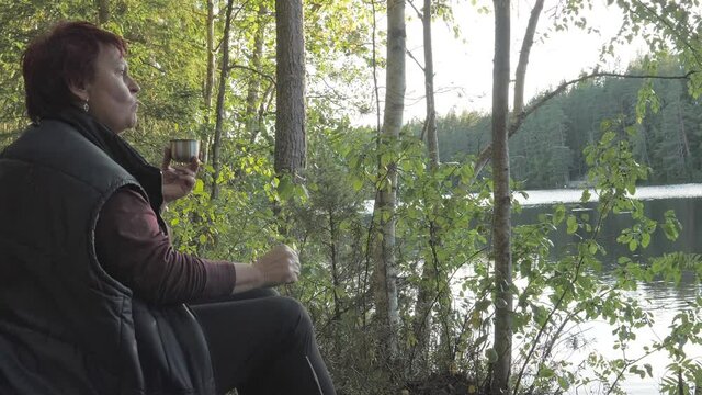The view of the nature reserve with the lady snacking in Espoo Finland