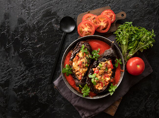 Karniyarik. Stuffed eggplant, eggplant with meat and vegetables, baked with tomato sauce, Turkish cuisine. Top view, close-up. Copy space
