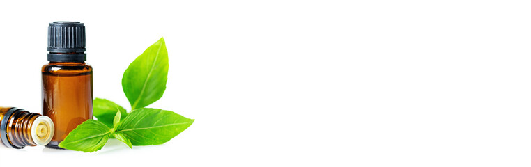 Essential oils in dark glass bottle with aroma herbs, long banner