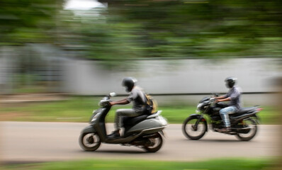 persons riding in bikes, blurred background