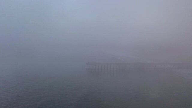 Static drone shot of fog surrounding Pismo Beach pier