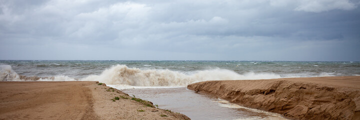 The river flows into a stormy sea.
