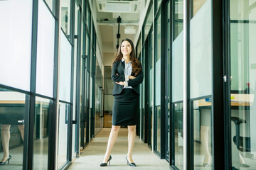 Asian businesswoman standing with folded hands