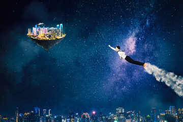 Obraz na płótnie Canvas Businessman flying toward a floating smart city