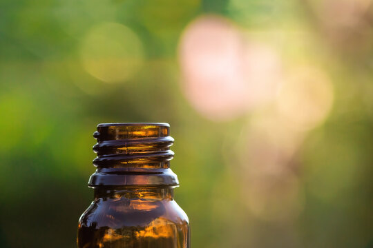 Essential aromatherapy concept, closeup of dark glass bottle