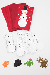 An aerial view of Christmas greeting card pieces to be assembled. Christmas crafting. Christmas flat lay isolated on white.