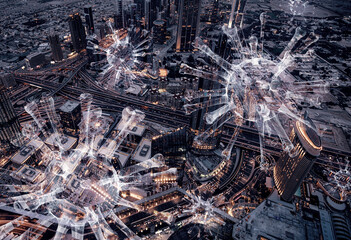 Aerial view of city at night and tree dimensional corona virus cells surrounding city.