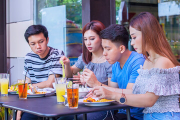 Group of enjoyed people having lunch in restaurant