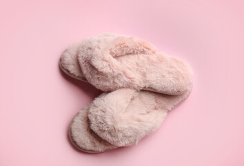 Fototapeta na wymiar Pair of stylish soft slippers on pink background, flat lay