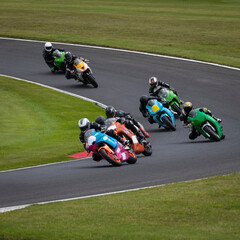 Fototapeta premium A shot of several racing bikes cornering as they circuit a track.