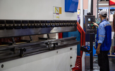 Industrial professional operating CNC synchronize hydraulic press brake bending machine. Industrial...