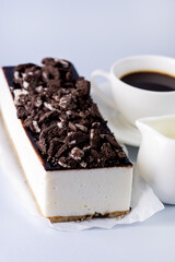 Tasty Homemade Vanilla Souffle or Mousse Cake Decorated with Chocolate and Cookies Cup of Black Coffee Cream Blue Background Tasty Holiday Dessert Vertical