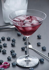 blueberry juice on a cocktail glass, front view. Selective focus