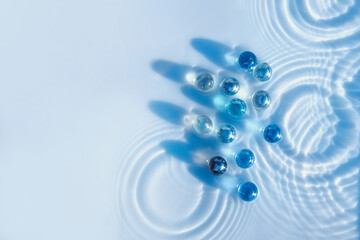 Cosmetic moisturizing emulsion with granules, serum or gel in blue color, abstract background for...