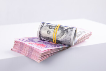 roll of dollars and hryvnias isolated on white background, close view