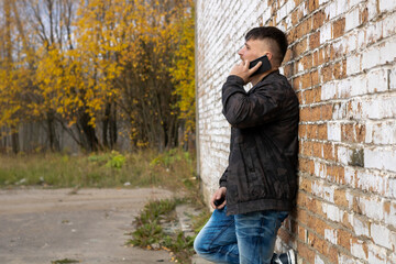 Bearded man against a brick wall. Autumn photo.