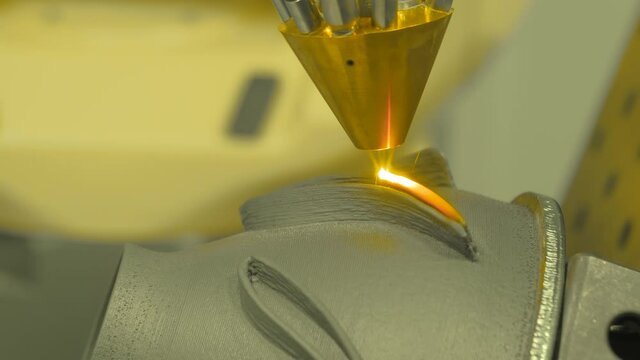 Metalworking, robotic, industrial concept. Direct metal deposition - advanced additive laser melting and powder spray manufacturing technology for repair, rebuild metal workpieces - close up