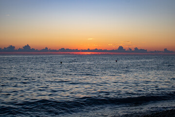 Fototapeta na wymiar Beautiful sunset over the sea overlooking the clouds and the horizon.