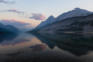 summers afternoon in the Kananaskis country of Alberta Canada. Lakes reflecting colorful clouds with wildflowers all around