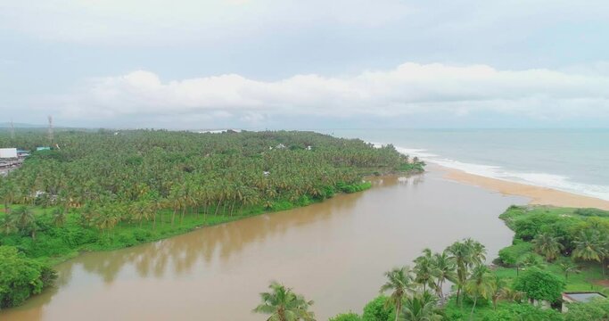 Aerial view of the estuary or a meeting place of river and sea took at Arabian sea Kerala during a rainy season filled with mud water