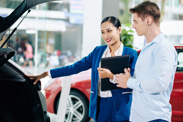 Customer asking car dealership manager to open trunk so he could look inside