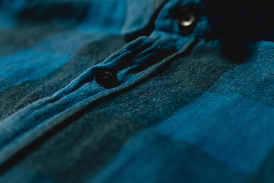 Closeup Of A Dark Blue Flannel Shirt Under The Lights