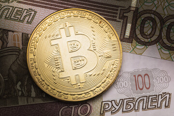 Bitcoin and Russian one hundred rubles close-up, top view