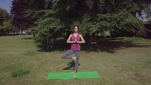 Young fit woman doing yoga, attractive confident woman doing yoga namaste pose