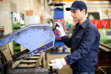 Worker near milling machine at factory