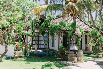 Balinese style villa design. Tropical garden, palm trees, traditional asian architecture. Hotel...