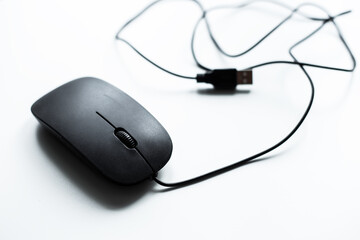 Isolated simple black computer mouse on white background. Flat lay top-down. minimal style