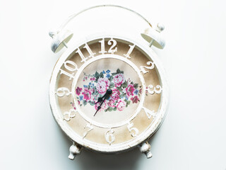 white alarm clock on white background. Flat lay top-down