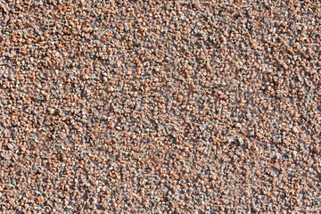 The wall of the public building is lined with fine granite chips. As a natural background.
