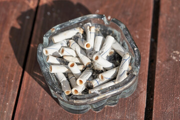 Many cigarette butts are in the ashtray