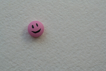 Pink Pill smile on on a beige background