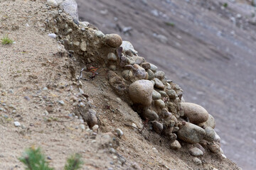 A pile of stones on the slope of a sand pit