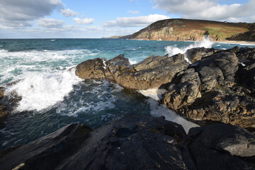 Incoming wave at a rock pool at Pendeen Cornwall