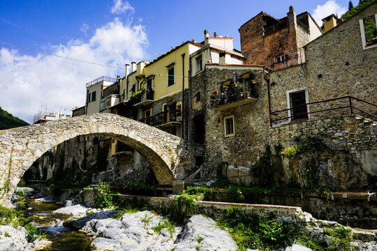 old bridge over the river in the village of Zuccarello, Savona, Italy