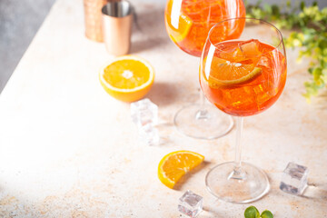 Aperol spritz cocktail in glass with fresh orange on light background