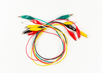 multi coloured test leads with alligator clips on a white background