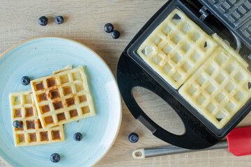 Waffles Being Baked in the Waffle Maker. Savory waffles. Breakfast concept